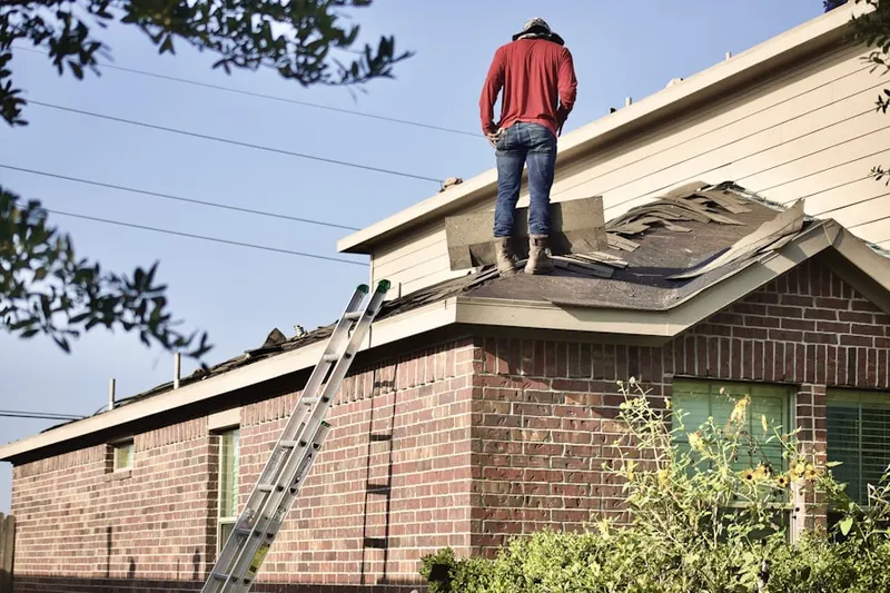 Professional roofer working on a residential roof in Llewellyn Park